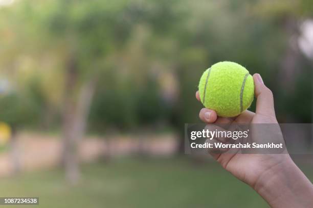 close-up tennis ball on hand. - tennis ball hand stock pictures, royalty-free photos & images