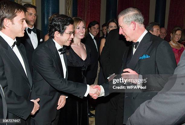 Prince Charles, Prince of Wales, President of The Prince's Foundation for Children and the Arts talks with guests at a charity gala dinner and...