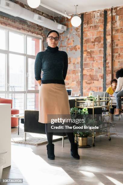 portrait of businesswoman standing in office - turtleneck stock pictures, royalty-free photos & images