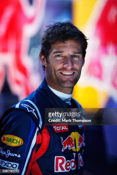 Mark Webber of Australia and Red Bull Racing poses for a photograph behind his team garage during day two of winter testing at the Ricardo Tormo...