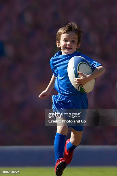 boy rugby player running with ball - kids rugby stock pictures, royalty-free photos & images