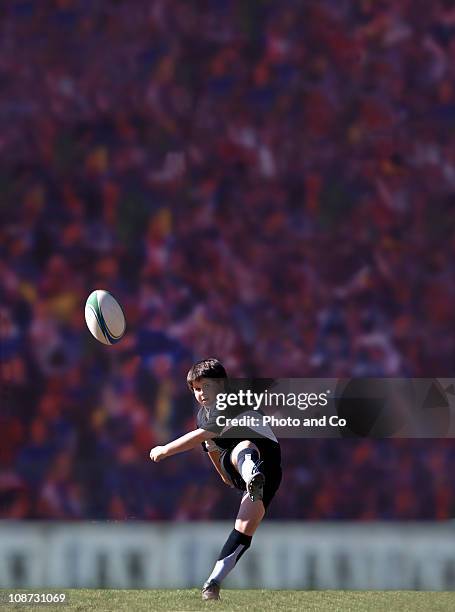 boy rugby player drop-kicking a ball - rugby ball kick stock pictures, royalty-free photos & images