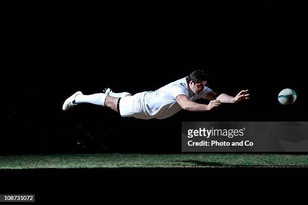 rugby player making a diving pass of the ball - ラグビー場 ストックフォトと画像