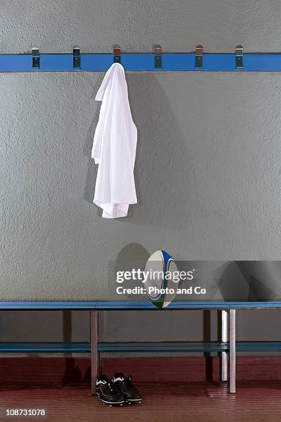 rugby jersey, ball and boots in change room (b&w) - maillot de sport photos et images de collection