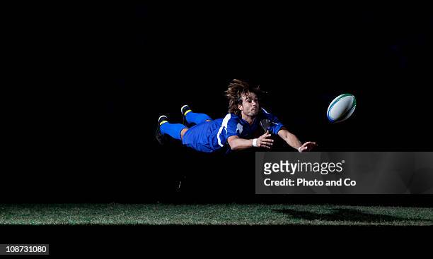 rugby player making a diving pass of the ball - diving to the ground bildbanksfoton och bilder