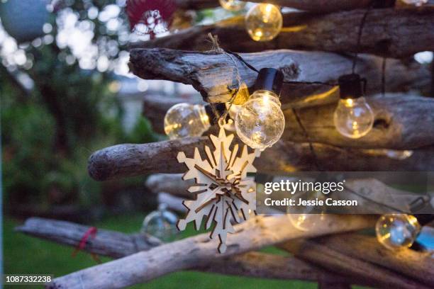 close up of light on creative  drift wood christmas tree - southern hemisphere fotografías e imágenes de stock