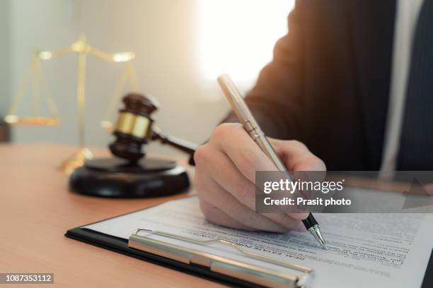 lawyer businessman working and notary signs the documents at office. consultant lawyer, justice and law ,attorney, court judge, concept. - notar stock-fotos und bilder