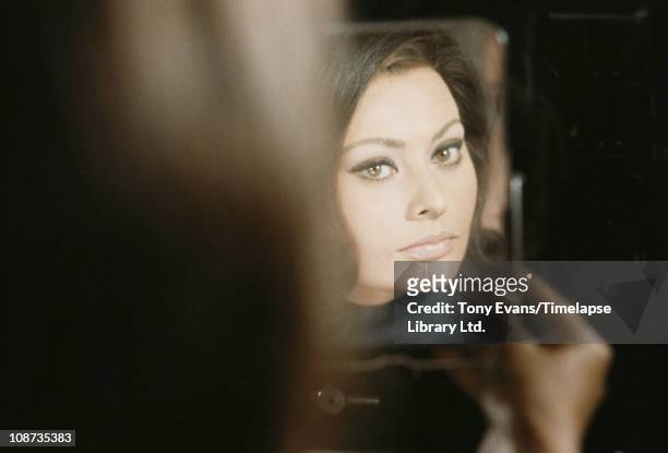 Italian actress Sophia Loren looking at herself on the set of 'Operation Crossbow', produced by Carlo Ponti, 1965.
