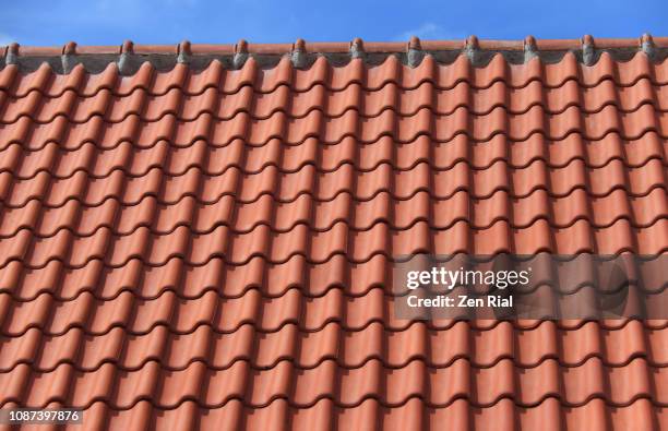 roof top with red terracotta roof tiles against blue sky - abundance tiles stock pictures, royalty-free photos & images