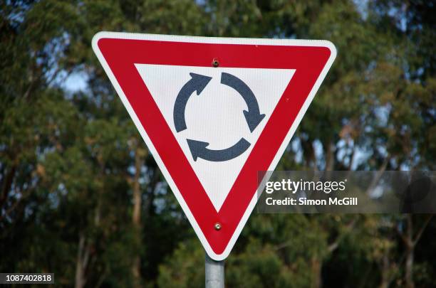 give way roundabout traffic circle sign - canberra stock pictures, royalty-free photos & images