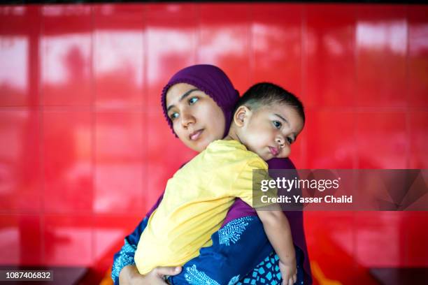 mother hug baby son - indonesian ethnicity stock pictures, royalty-free photos & images