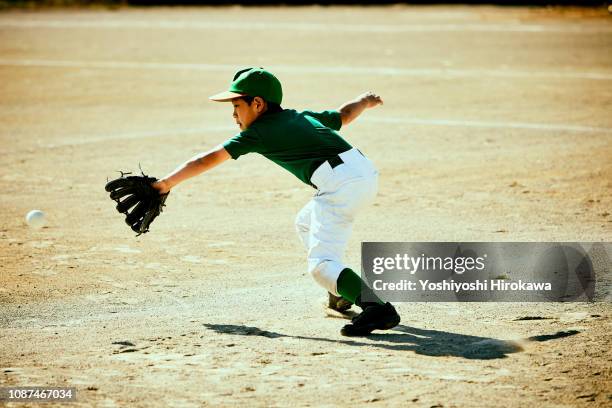baseball boy(6-7)diving to catch ball - high school baseball stock pictures, royalty-free photos & images