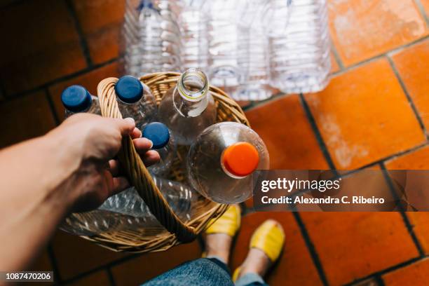 personal perspective woman recycling plastic in basket - holding bottle stock pictures, royalty-free photos & images