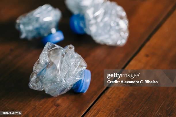 crumpled, recycled plastic water bottles - crushed plastic stock pictures, royalty-free photos & images