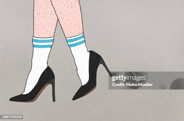 low section of person with hairy legs wearing sports socks and high heels - hairy man stockfoto's en -beelden