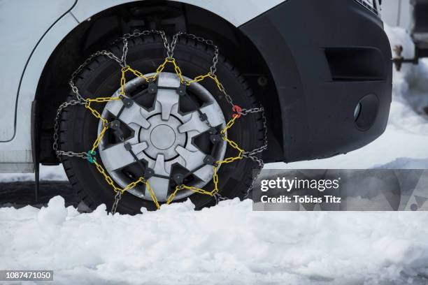 snow chains on parked car - extreme weather snow stock pictures, royalty-free photos & images