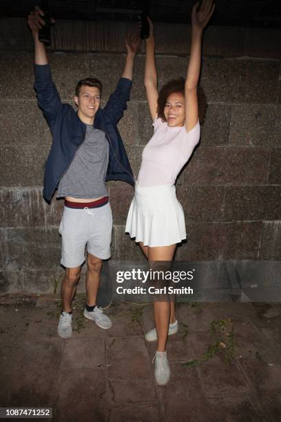 portrait exuberant young couple drinking beer and cheering - berlin nightlife stock pictures, royalty-free photos & images