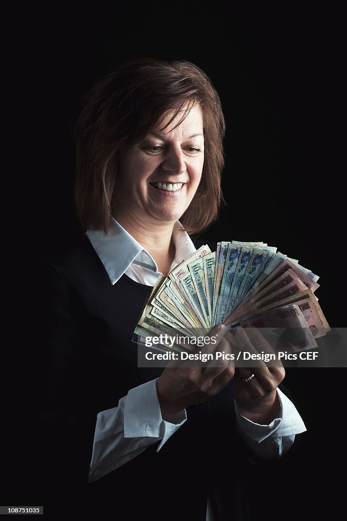 A Woman Fanning Out Dollar Bills