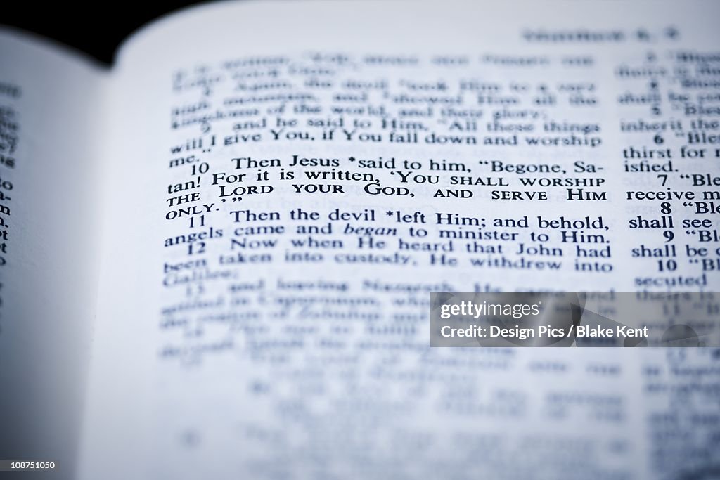 The Bible Open To Matthew 4:10 Where Jesus Is Tempted In The Wilderness