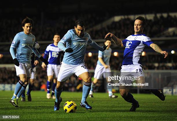 Carlos Tevez of Manchester City shoots past Martin Jiranek of Birmingham City to score during the Barclays Premier League match between Birmingham...