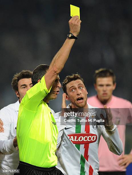 Referee Emidio Morganti issues a yellow card to Claudio Marchisio of Juventus during the Serie A match between US Citta di Palermo and Juventus FC at...