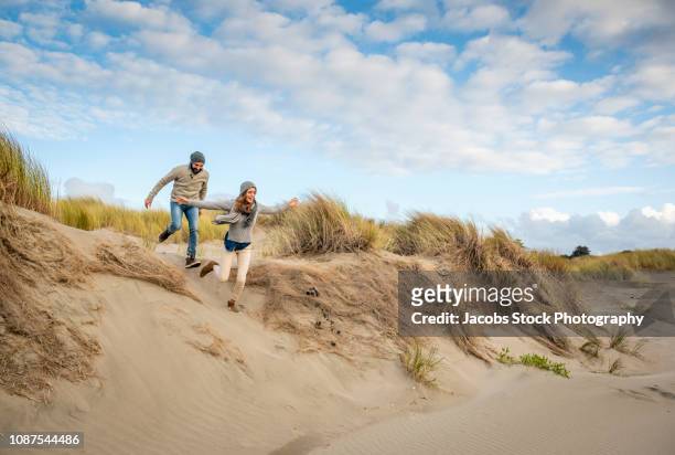 couple having fun at the beach - couple dunes stock-fotos und bilder
