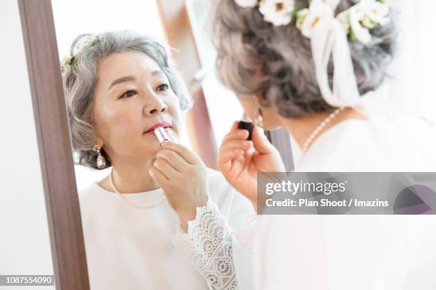 couple doing makeup and looking at mirror - woman lipstick rearview stock pictures, royalty-free photos & images