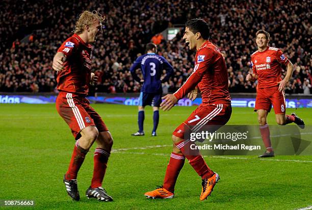 Luis Suarez of Liverpool celebrates with team-mate Dirk Kuyt after scoring the 2-0 goal during the Barclays Premier League match between Liverpool...