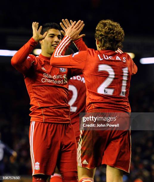 Liverpool's new signing Luis Suarez celebrates his 2-0 goal with team-mates Lucas during the Barclays Premier League match between Liverpool and...