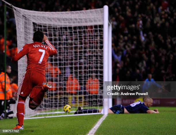 Luis Suarez of Liverpool celebrates his 2-0 goal while Andy Wilkinson of Stoke lies dejected on the pitch during the Barclays Premier League match...