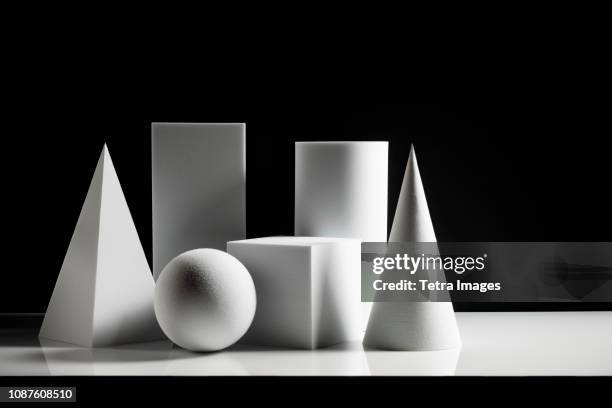 geometric shapes against black background - shadow cone stock pictures, royalty-free photos & images