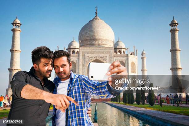 two friends taking a selfie at the taj mahal in agra, india - taj mahal selfie stock pictures, royalty-free photos & images