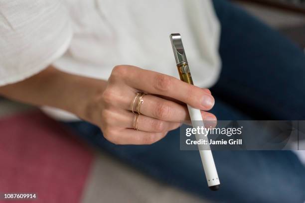 hand of woman holding electronic cigarette - electronic cigarette ストックフォトと画像