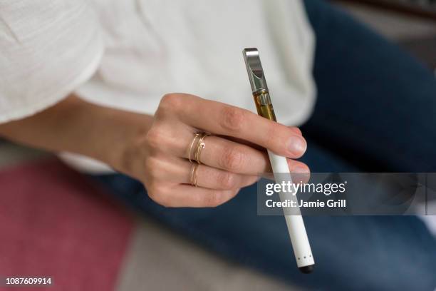 hand of woman holding electronic cigarette - e cigarettes stock pictures, royalty-free photos & images