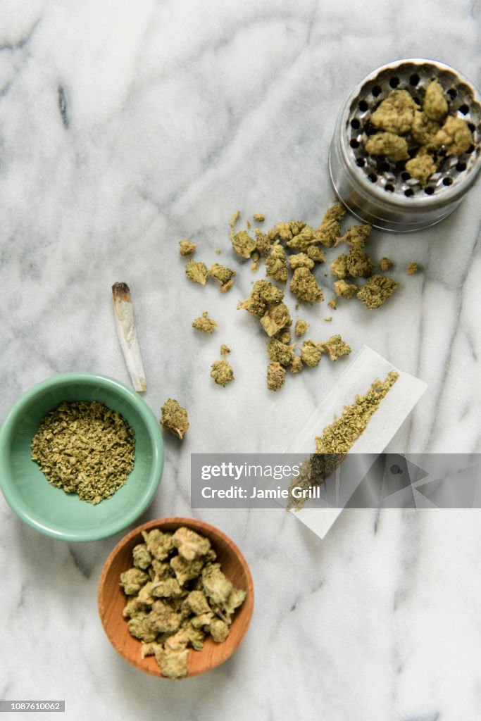 Marijuana with bowl, grinder, and rolling paper