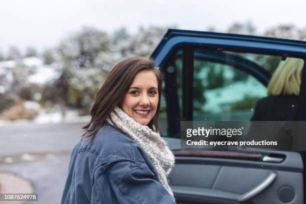 female mixed ethnic group friends winter drive and walk in a national park on a snowy day - ethnic woman driving a car stock pictures, royalty-free photos & images