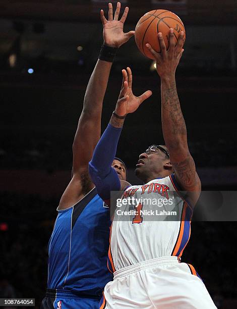 Amar'e Stoudemire of the New York Knicks shoots the b all against Brendan Haywood of the Dallas Mavericks at Madison Square Garden on February 2,...