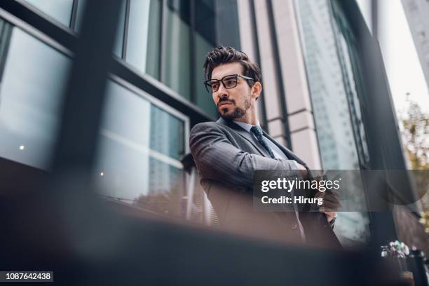 stylish handsome man reaching pocket on his jacket - jacket pocket stock pictures, royalty-free photos & images
