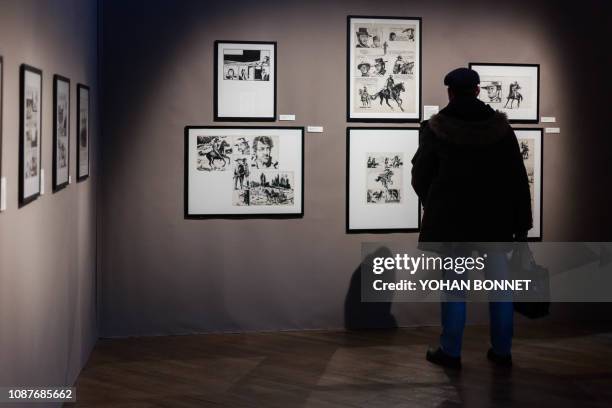 Man visits an exhibition dedicated to Italian cartoonist Milo Manara entitled in French "Manara, itineraire d un maestro de Pratt a Caravage" on...