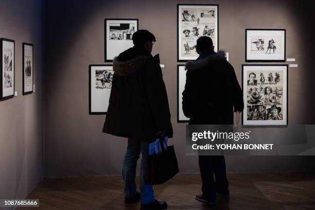 People visit an exhibition dedicated to Italian cartoonist Milo Manara entitled in French "Manara, itineraire d un maestro de Pratt a Caravage" on...