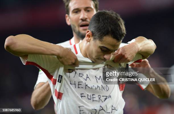 Sevilla's French forward Wissam Ben Yedder shows a t-shirt reading "To my brother, be strong, E. Sala" supporting Cardiff City FC's Argentinian...