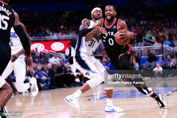 Terrence Ross of the Orlando Magic defends against C.J. Miles of the Toronto Raptors in the second quarter at Amway Center on December 28, 2018 in...