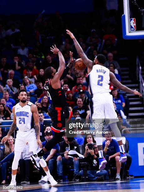 Jarell Martin of the Orlando Magic blocks an attempted basket by C.J. Miles of the Toronto Raptors in the fourth quarter at Amway Center on December...
