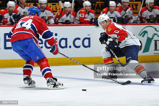 David Booth of the Florida Panthers attempts to skate past defenceman Roman Hamrlik of the Montreal Canadiens during the NHL game on February 2, 2011...