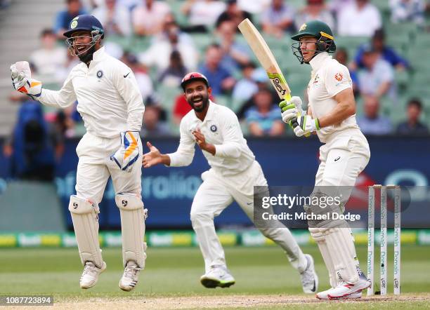 Tim Paine of Australia reacts after his dismissal as Rishabh Pant of India celebrates during day four of the Third Test match in the series between...