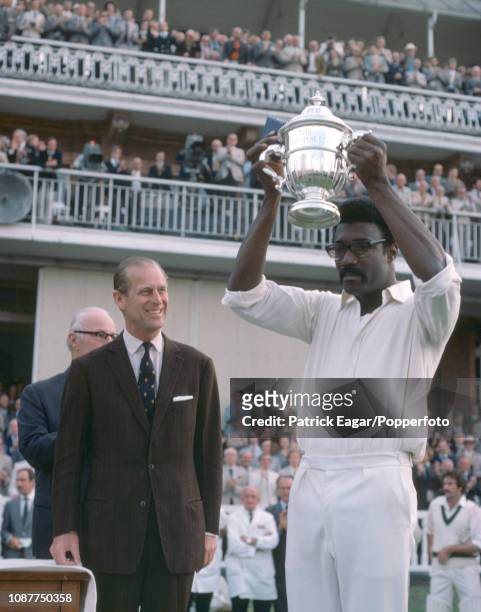 West Indies captain Clive Lloyd lifts the Prudential World Cup after it was presented to him by HRH Prince Philip after the World Cup Final between...