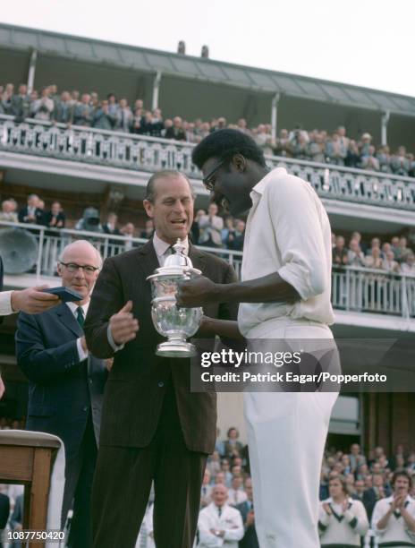West Indies captain Clive Lloyd is presented with the Prudential World Cup by HRH Prince Philip during the presentation ceremony after the World Cup...
