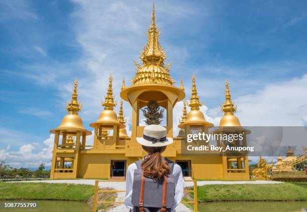 back view of asian tourist looking to beautiful ganesha shrine in wat rong kun, thailand. - chiang rai province stock pictures, royalty-free photos & images