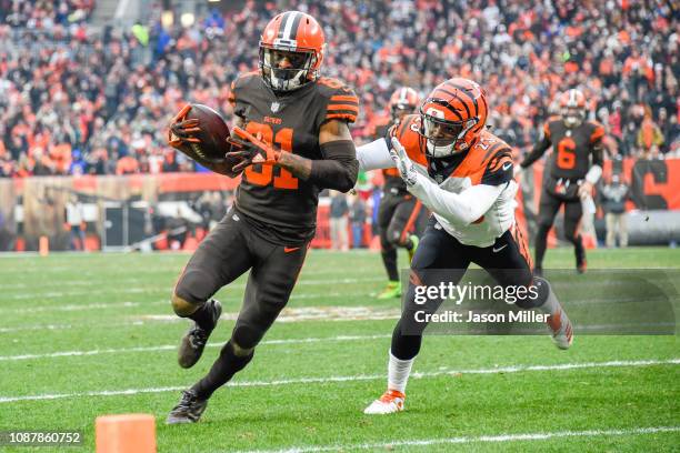 Wide receiver Rashard Higgins of the Cleveland Browns evades a take from cornerback Darius Phillips of the Cincinnati Bengals to score a touchdown...