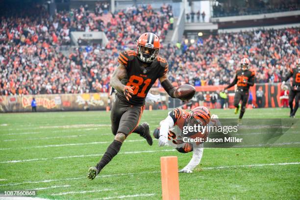 Wide receiver Rashard Higgins of the Cleveland Browns evades a take from cornerback Darius Phillips of the Cincinnati Bengals to score a touchdown...